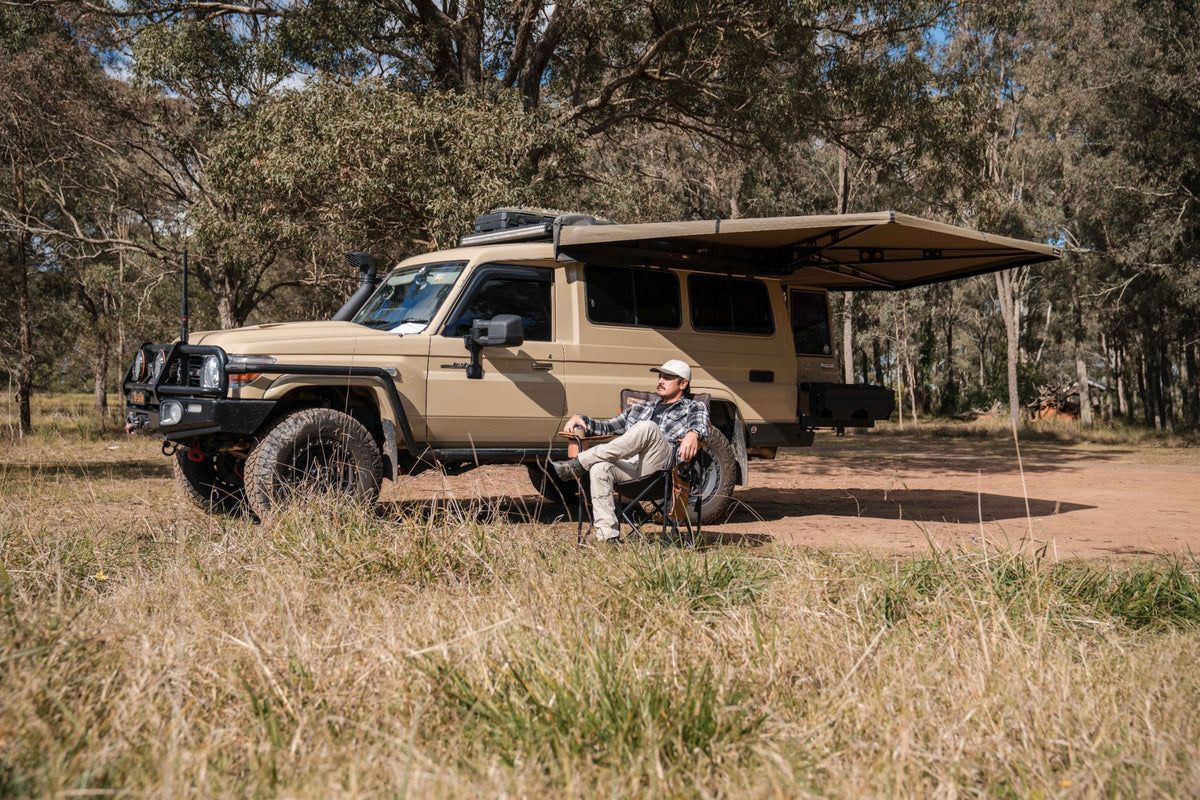 Roody camping chair beside an off-road vehicle