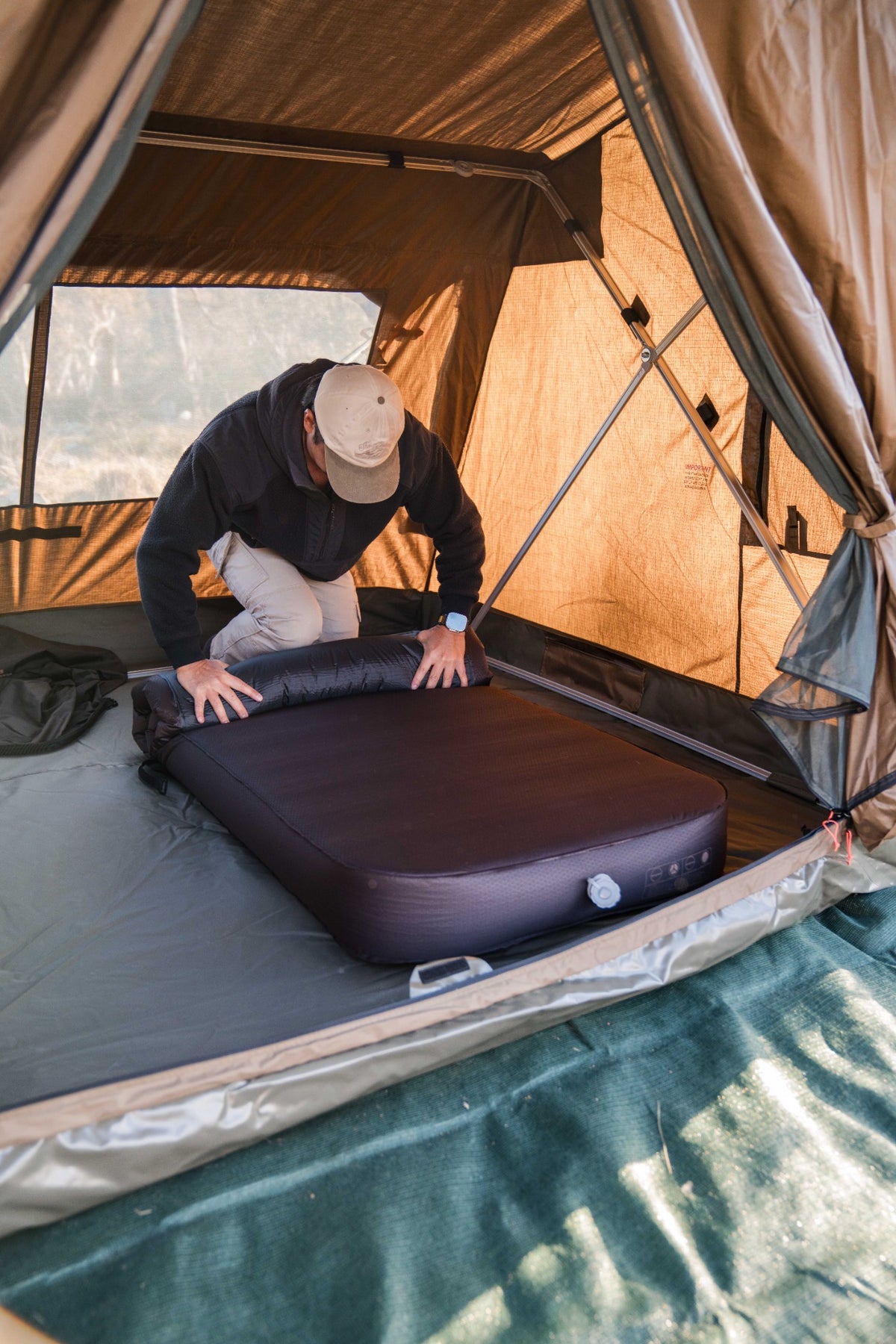 Setting up a Roody self-inflating mattress inside a tent